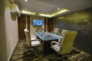 a conference room with chairs and a table and a tv at Hotel JRD Exotica-Business Hotel in New Delhi