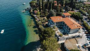 an aerial view of a house on the water at Hotel Villa Maria Au Lac - Estella Hotels Italia in Toscolano Maderno