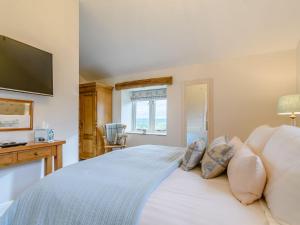 a bedroom with a bed with a tv on the wall at Middle Mistal in Stainburn