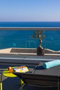 a table with a surfboard sitting on top of a balcony at Hôtel Riva Art & Spa in Menton