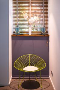 a yellow table in a room with a window at Hôtel Riva Art & Spa in Menton
