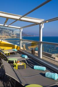 a deck on a cruise ship with tables and chairs at Hôtel Riva Art & Spa in Menton