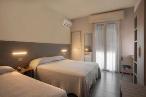 Postel nebo postele na pokoji v ubytování Hotel Norma