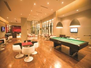 a billiard room with a pool table and chairs at Keys Select by Lemon Tree Hotels, Hosur Road, Bengaluru in Bangalore
