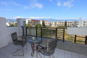 a patio with a table and chairs on a balcony at Dali Moonlight B&B in Taitung City