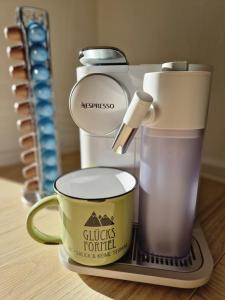 a coffee maker and a cup on a table at Haus Bergler in Blaichach