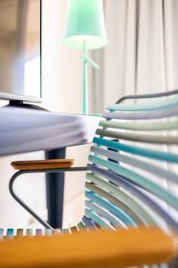 a stack of plates on a desk with a lamp at Hôtel Riva Art & Spa in Menton