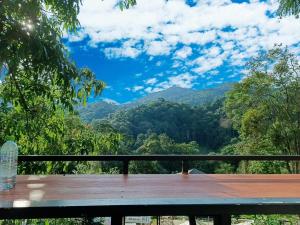a picnic table with a view of the mountains at บ้านชายดอย Glamping ดอยแม่แจ๋ม cheason ,Muangpan, Lampang in Ban Mai