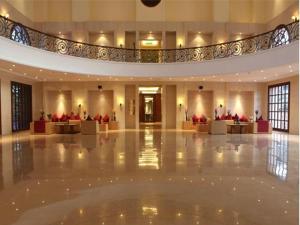 a large lobby with couches and tables in a building at Evershine Resort & Spa in Mahabaleshwar