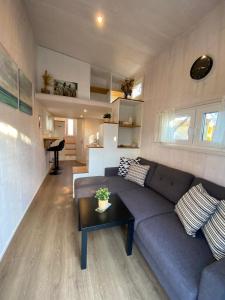 a living room with a couch and a table at Tiny House Stever im PIER9 Tiny House Hotel in Hamm