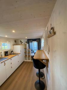 a small kitchen with a table and a stool at Tiny House Stever im PIER9 Tiny House Hotel in Hamm