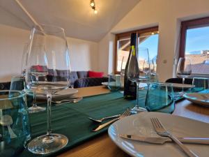 a table with wine glasses on a green table cloth at Haus Bergler in Blaichach