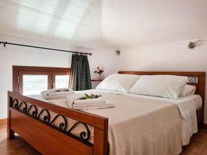 1 dormitorio con 1 cama grande y 2 toallas. en Villa Kostoula, en Karavomylos