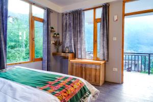 1 dormitorio con 1 cama y balcón con ventanas en Bros Hostel & Yaara Cafe, en Manali