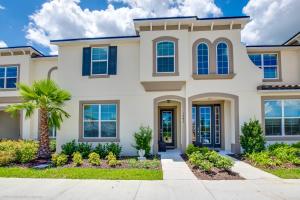 a house with a palm tree in front of it at Solara Resort - 5 Bed 4,5 Baths TOWNHOME in Orlando