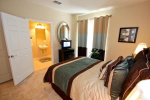 a bedroom with a bed and a bathroom with a sink at IT319 - Vista Cay Resort - 3 Bed 3,5 Baths Townhome in Orlando