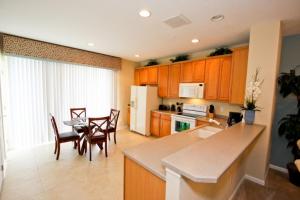 a kitchen and dining room with a table and chairs at IT319 - Vista Cay Resort - 3 Bed 3,5 Baths Townhome in Orlando