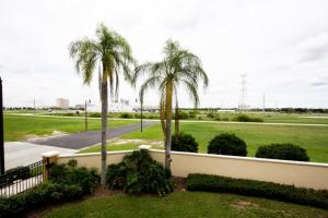 two palm trees in a yard next to a fence at IT319 - Vista Cay Resort - 3 Bed 3,5 Baths Townhome in Orlando