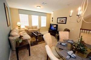 a living room with couches and a tv at IT319 - Vista Cay Resort - 3 Bed 3,5 Baths Townhome in Orlando