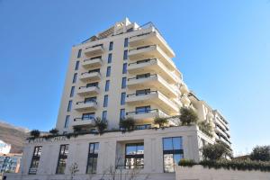a tall white building with plants on it at CASA AL MARE RESIDENCE in Bečići
