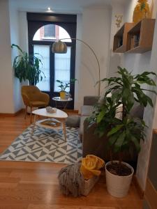 a living room with a couch and a table at MenVal16 in Gijón