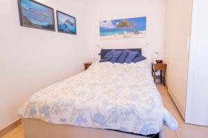 1 dormitorio con 1 cama con edredón azul y blanco en 113 - Casa Le Terrazze in centro 100 metri Mare Spiaggia, BOX AUTO GRATIS, en Sestri Levante