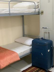 a blue suitcase sitting on the floor next to a bunk bed at Dubai Creek in Dubai