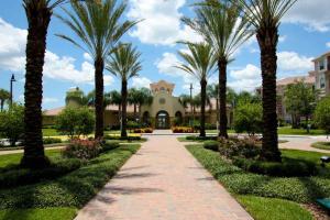 a walkway through a park with palm trees at IT289 - Vista Cay Resort - 3 Bed 2 Baths Condo in Orlando