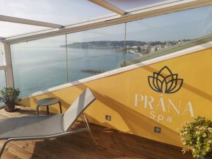 a view from the balcony of a room with a yellow sign at Hôtel Riva Art & Spa in Menton