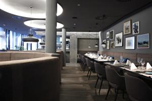 a dining room with long tables and chairs at Badhaus - Hotel/Restaurant/Café in Bad Hall