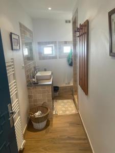 a bathroom with a sink and a toilet and a mirror at Charming apartment overlooking the lake city in Grimaud