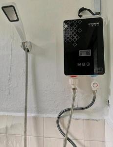 a cell phone is plugged into a wall at SPOT ON 90735 night Stayin in Sibu
