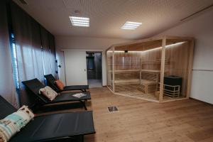 a living room with a couch and a room with a large wooden closet at An der Lage in Spielfeld