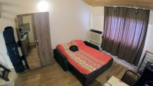 a bedroom with a bed with a red comforter at Mary Apartment Gudauri Residence in Gudauri