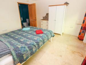 a bedroom with a bed and a dresser in it at Cranny in Narberth