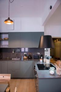 Una cocina con gabinetes grises y una encimera negra. en RELAIS DEI GOTI, en Roma 25 fotos más