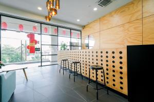 a restaurant with tables and chairs and a wall of windows at 3C HOTEL Setia Walk Puchong in Puchong
