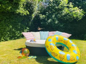 a couch and a donut sitting in the grass at Hotel Schaepkens van St Fijt in Valkenburg +25 photos