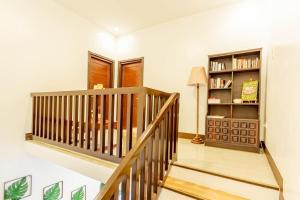 a staircase in a home with a book shelf at Coca Cabana in Porac