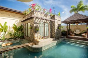 a house with a swimming pool and a house at Coca Cabana in Porac