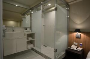 a bathroom with a shower and a sink at Smile Inn - Taipei Main Station in Taipei