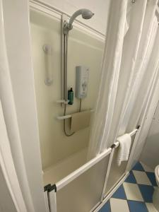 a shower with a shower curtain in a bathroom at Tiverton Hotel Lounge & Venue formally Best Western in Tiverton