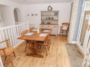 a dining room with a wooden table and chairs at Rosemount in Marazion