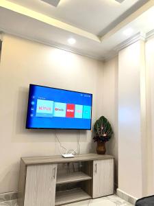 a flat screen tv on a wall in a room at Regency Stays in Eldoret
