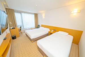 Postel nebo postele na pokoji v ubytování Mstay Hotel