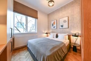 a bedroom with a bed and a large window at Designer Central Getaway in Cluj-Napoca