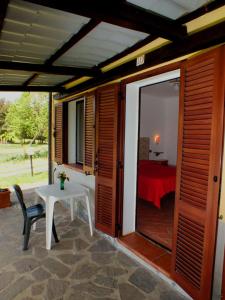a patio with a white table and a bedroom at Il Bettarello in Roccastrada