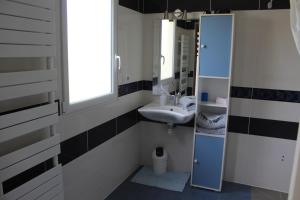 een badkamer met een wastafel en een spiegel bij B&B La Lyre in Saint-Georges-du-Bois