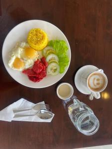 a bowl of eggs and vegetables and a cup of coffee at Eight Breeze in Baclayon