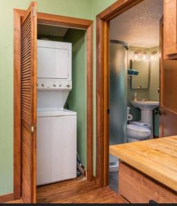 a kitchen with a refrigerator and a toilet in it at $99 midweek-2 bedroom-Riverfront-Fireplace- Pet ok in Pine City